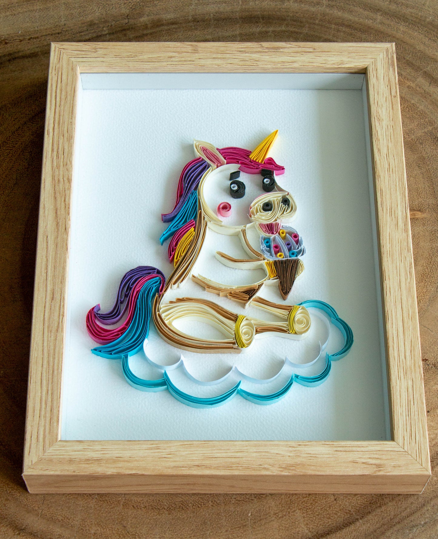 Small baby Unicorn eating ice-cream from paper. Baby room present quilling artwork. ArtyMargarita.com Unique artworks from paper