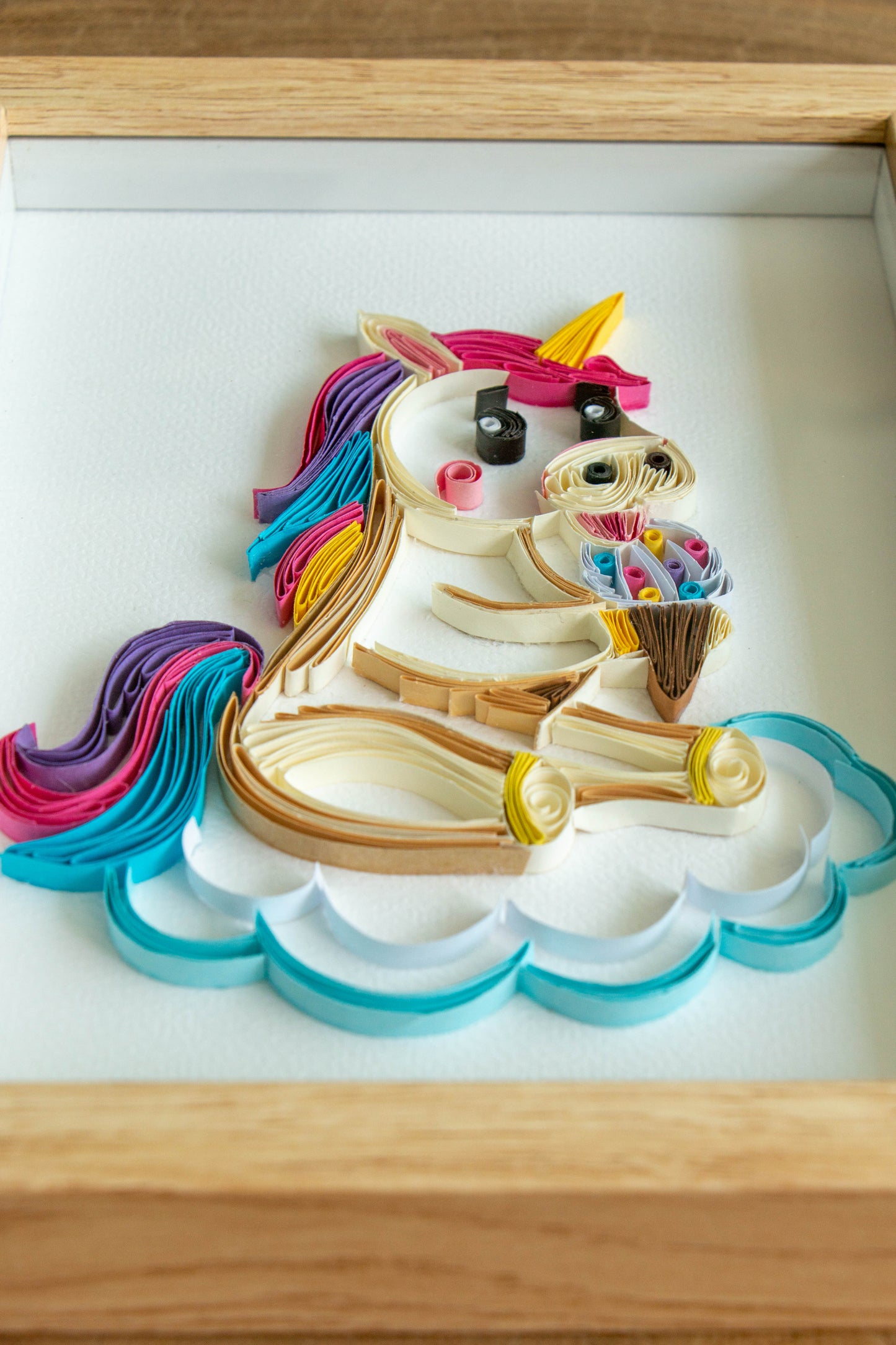 Small baby Unicorn eating ice-cream from paper. Baby room present quilling artwork. ArtyMargarita.com Unique artworks from paper