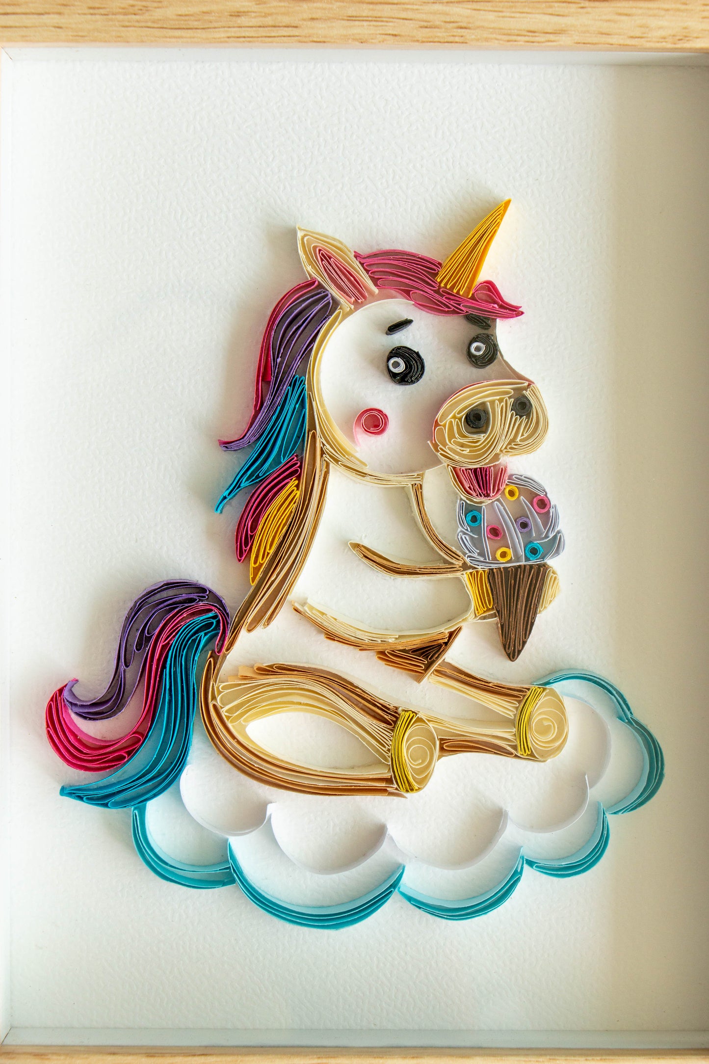 Small baby Unicorn eating ice-cream from paper. Baby room present quilling artwork. ArtyMargarita.com Unique artworks from paper